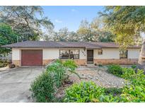 Charming single-story home featuring a stone facade, well-manicured landscaping, and a cozy front yard at 1912 Se 169Th Ct, Silver Springs, FL 34488