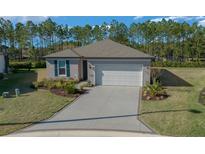 Charming single Gathering home featuring a two-car garage and lush landscaping at 6185 Sw 89Th Ct, Ocala, FL 34481