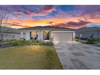 Charming single-story home with neutral paint, landscaped yard, stone accents, and a spacious two-car garage at 8719 Sw 76Th Street Rd, Ocala, FL 34481