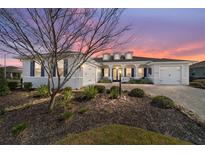 Charming home featuring blue shutters, a brick driveway, and meticulous landscaping at 8864 Sw 85Th Loop, Ocala, FL 34481