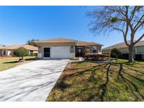 Inviting single-story home featuring a two-car garage and well-maintained landscaping at 9167 Sw 99Th Court Rd, Ocala, FL 34481