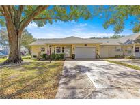 Charming single-story home featuring a large driveway, attached garage, and well-maintained landscaping at 9335 Sw 85Th Ter # A, Ocala, FL 34481