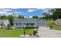 Charming single-story home with well-manicured lawn and attached two-car garage at 10821 Sw 87Th Ter, Ocala, FL 34481