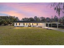 Charming single-story home features a well-manicured lawn and convenient carport at 165 Ne 43Rd Ave, Ocala, FL 34470