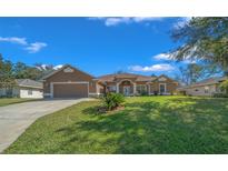 Charming single-story home with a manicured lawn and welcoming front entrance at 2301 Se 24Th Ave, Ocala, FL 34471