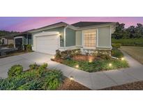 Charming one-story home with lush landscaping and a well-lit walkway leading to the front entrance at 6780 Sw 91St Cir, Ocala, FL 34481