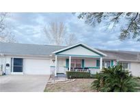 Charming single-story home featuring a cozy front porch and attached one-car garage at 8685 Sw 94Th Ln # B, Ocala, FL 34481