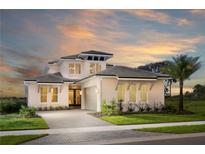 Stunning two-story home featuring a paver driveway, well-manicured lawn, and lush landscaping at 0000 Se 47Th Loop, Ocala, FL 34480