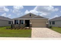 Charming single-story home featuring a two-car garage, manicured lawn, and lovely stone accents at 4008 Nw 48Th Terrace Rd, Ocala, FL 34482