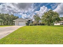 Charming one-story brick home featuring a well-manicured lawn and attached two car garage at 5902 Sw 112Th Place Rd, Ocala, FL 34476