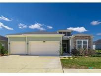 Charming single-Gathering home with a two-car garage, well-maintained lawn, and stone accents at 7374 Sw 77Th Ave, Ocala, FL 34481