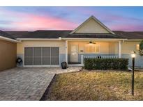 Charming home featuring a screened garage, inviting front porch, and well-maintained landscaping at 9504 Sw 97Th Ln # B, Ocala, FL 34481