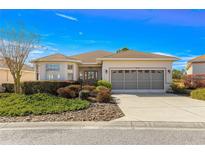 Charming home with a well-manicured front yard and inviting curb appeal on a sunny day at 10055 Sw 90Th Loop, Ocala, FL 34481