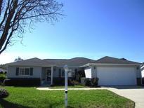 Charming single-story home with a well-manicured lawn and an attached two-car garage at 11552 Sw 138Th Ln, Dunnellon, FL 34432