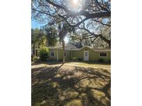 Charming single-story home with a lush, tree-filled front yard and a quaint, welcoming entrance at 18434 Se 24Th St, Silver Springs, FL 34488