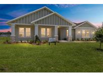 Charming single-story home featuring a welcoming front porch and lush green lawn at 1929 Nw 85Th Loop, Ocala, FL 34475