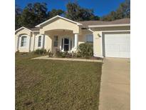 Charming single-story home with a well-maintained lawn and attached two-car garage at 2637 Ne 27Th St, Ocala, FL 34470