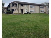 Condo exterior shows well-maintained lawn and neutral paint scheme at 2923 Antique Oaks Cir # 39, Winter Park, FL 32792
