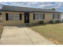 Charming single-story home featuring a well-manicured front yard and a welcoming entrance at 4 Pine Pass Ter, Ocala, FL 34472