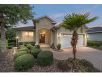 Charming single-story home featuring a manicured front yard and a welcoming entrance at 8670 Sw 88Th Pl, Ocala, FL 34481
