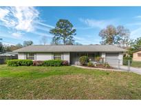 Charming single story home featuring manicured landscaping with vibrant green bushes and azaleas in front yard at 3204 Ne 16Th Ave, Ocala, FL 34479