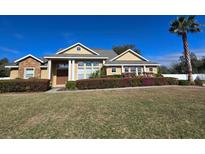 Inviting single-story home featuring well-manicured landscaping and a symmetrical facade against a bright blue sky at 3401 Se 49Th Ave, Ocala, FL 34480