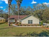 Charming single-story home featuring a well-manicured lawn and classic architectural details at 5115 Se 20Th St, Ocala, FL 34480