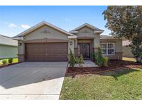 Charming single-story home with a well-maintained lawn and a two-car garage at 5464 Sw 41St St, Ocala, FL 34474