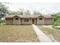 Inviting single-story home features classic siding and well-manicured lawn offers a warm, welcoming curb appeal at 5490 Se Highway 42, Summerfield, FL 34491