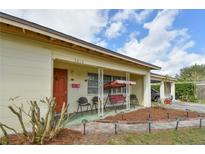 Charming front porch with porch swing, seating, and cozy landscaping featuring a brick-lined walkway with in-ground lighting at 5812 Luzon Pl, Orlando, FL 32839