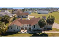 Charming single-story home with a well-manicured lawn and lush palm trees in a lovely neighborhood at 8947 Se 70Th Ter, Ocala, FL 34472