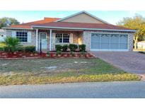 Charming single-story brick home with a well-manicured front yard and a convenient two-car garage at 9681 Sw 97Th Ln, Ocala, FL 34481