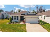 Charming single-story home featuring a well-manicured lawn, a two-car garage, and stone accents for added curb appeal at 5370 Sw 45Th Ave, Ocala, FL 34474