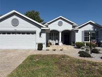 Charming single-story home featuring a well-manicured lawn and covered entryway, perfect for welcoming guests at 8504 Sw 84Th Loop, Ocala, FL 34481