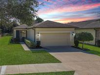 Charming single-story home boasts a well-manicured lawn and inviting two-car garage at 9480 Sw 76Th St, Ocala, FL 34481