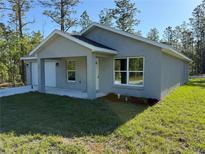 Charming single-Gathering home with a two-car garage and a well-manicured lawn at 107 Sw Alvarez Rd, Dunnellon, FL 34431