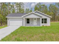 Charming single-story home featuring a one-car garage and a well-maintained lawn at 107 Sw Alvarez Rd, Dunnellon, FL 34431