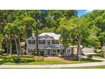 Charming two-story home with a covered porch and mature trees, providing ample shade and curb appeal at 1628 Se 29Th Ter, Ocala, FL 34471