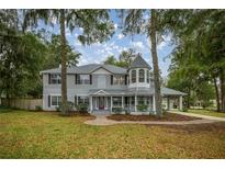 Charming two-story home featuring a welcoming front porch and a unique turret design at 1628 Se 29Th Ter, Ocala, FL 34471