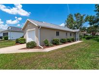 Charming home featuring a well-manicured lawn, attached garage, and meticulously maintained landscaping at 5207 Nw 18Th St, Ocala, FL 34482