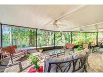 A spacious screened-in patio with comfortable seating provides stunning views of the lake at 11720 Cherokee Cir, Dunnellon, FL 34431