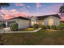 Charming single-story home with well-manicured landscaping, lush lawn, and a two-car garage in a quiet neighborhood at 2318 Nw 50Th Ave, Ocala, FL 34482