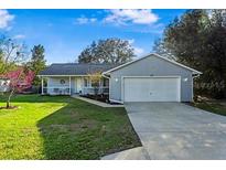 Charming single-story home with well-maintained lawn and attached two-car garage at 53 Juniper Trail Cir, Ocala, FL 34480