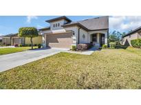 Charming one-story home with a two-car garage, well-manicured lawn and beautiful landscaping at 7234 Sw 91St Ct, Ocala, FL 34481
