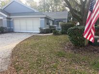 Charming home with tidy landscaping, two-car garage, and an American flag flying proudly at 8037 Sw 115Th Loop Loop # B, Ocala, FL 34481