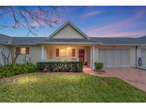 Charming home with a covered front porch, lush landscaping, and a two-car garage at 9272 Sw 97Th Pl # B, Ocala, FL 34481