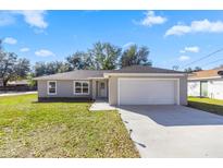 Charming single-story home with a well-manicured lawn and an attached two-car garage at 13458 Sw 113Th Pl, Dunnellon, FL 34432