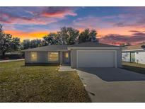 Charming single-story home with a well-manicured lawn and a two-car garage, perfect for suburban living at 13458 Sw 113Th Pl, Dunnellon, FL 34432