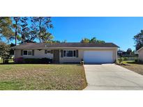 Charming single-story home features a well-maintained lawn, attached garage, and a cozy, inviting facade at 8516 Sw 105Th Pl, Ocala, FL 34481