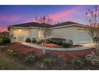 Charming single-story home with a well-manicured lawn, mature landscaping and two car garage at 10071 Sw 90Th Loop, Ocala, FL 34481